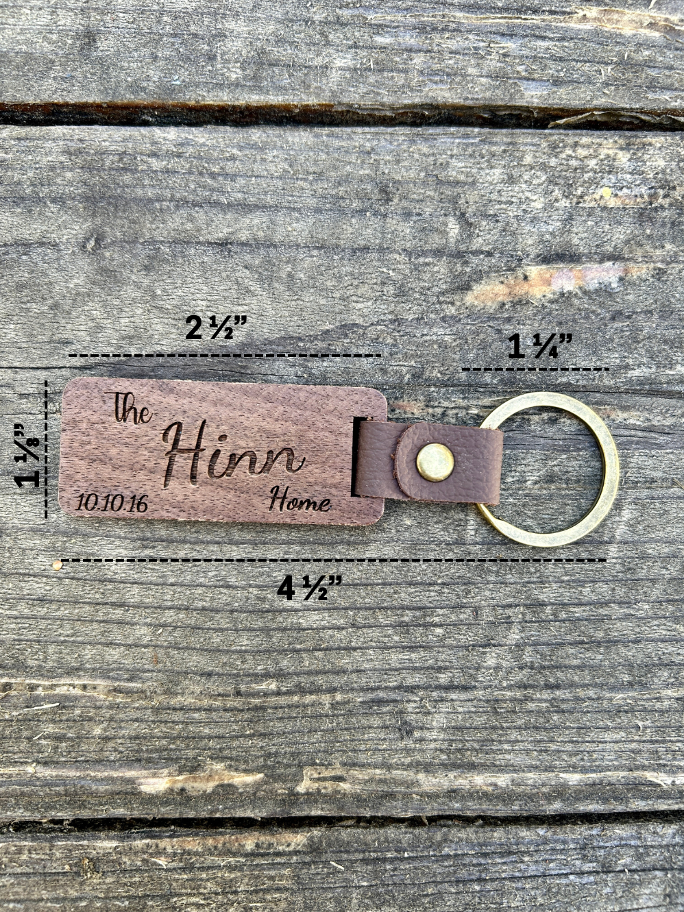 Wooden keychain with measurements on a wooden background