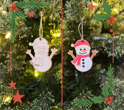 Two wooden snowman ornaments on a Christmas tree with greenery and lights.