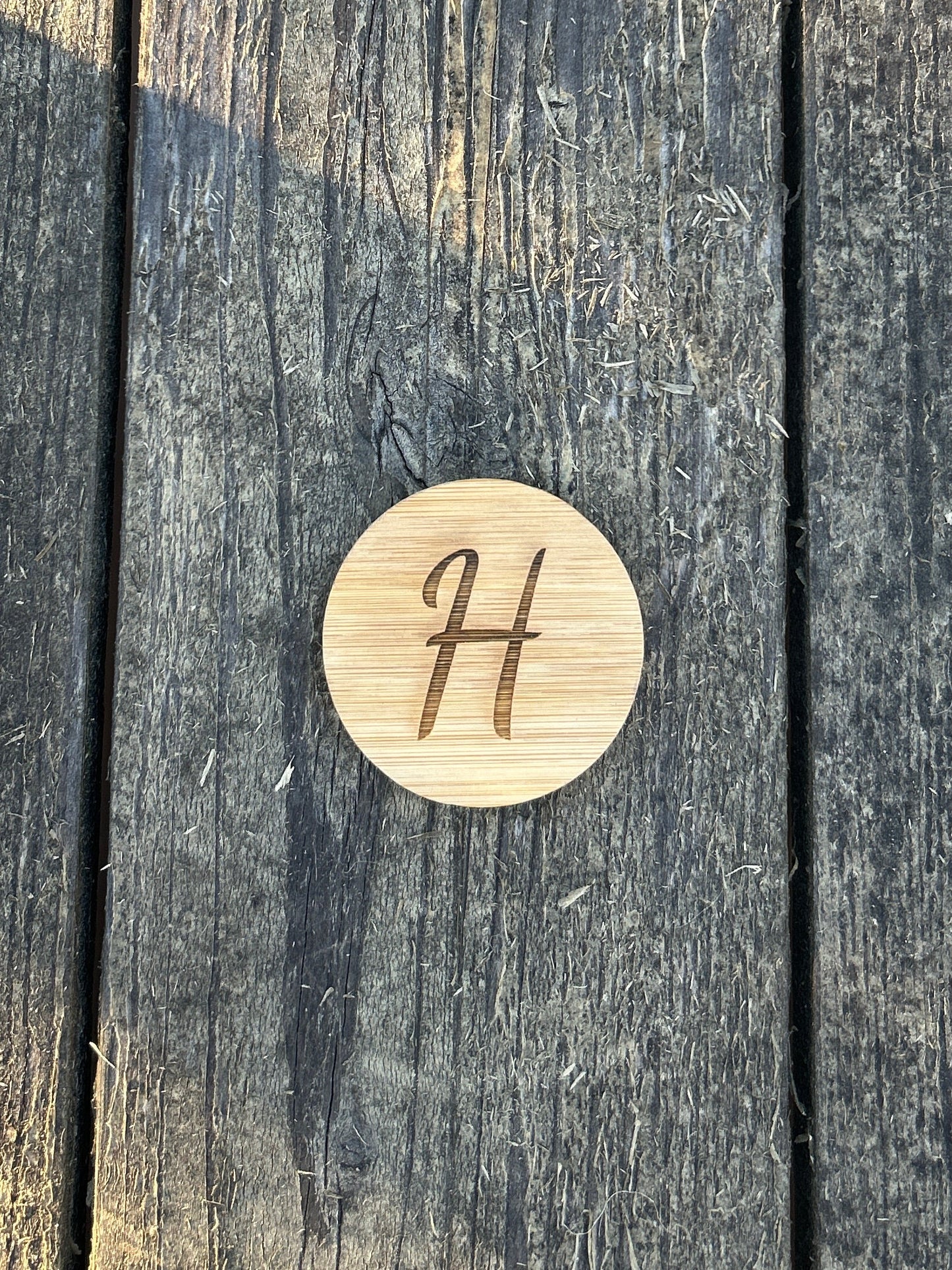round wooden bottle opener with a magnet, customized with an initial