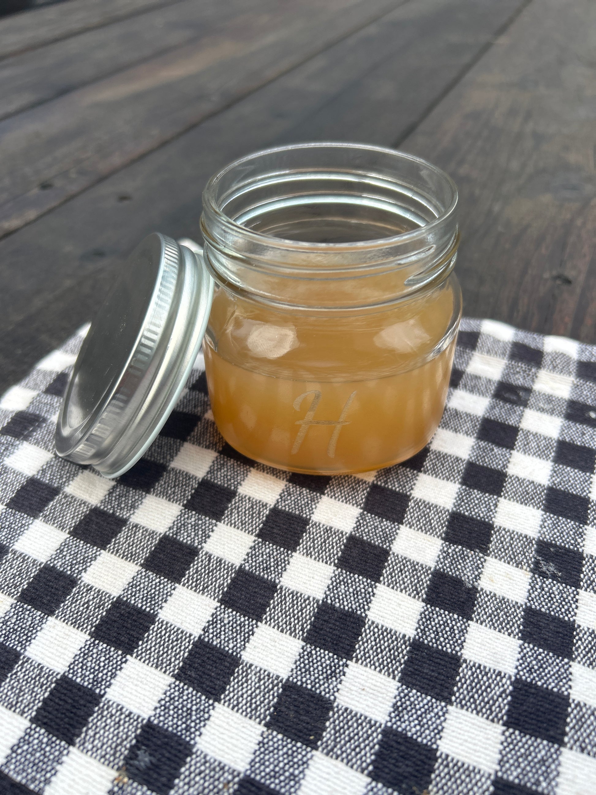 Jar of juice on a checkered tablecloth