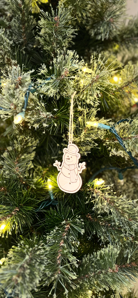 Decorative snowman ornament on a Christmas tree with lights.